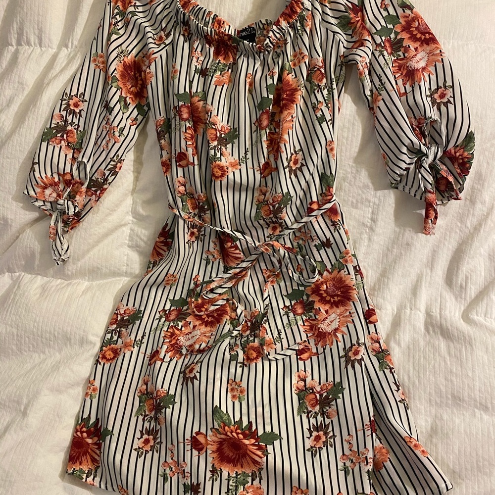 White blouse with black lines and pink flowers